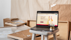 A laptop with mailchimp.com on the screen, resting in a new storefront under construction.