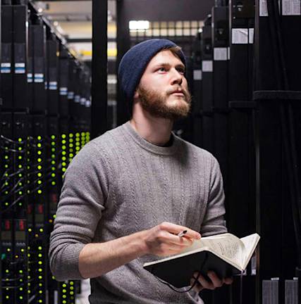A photo of a man in a data center.