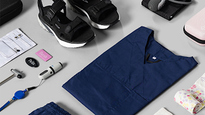 Flat lay collection of navy blue and black business items including clothing, accessories, and electronics on light gray background