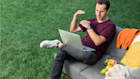 A man taking a video call from outside, gesturing as he talks about a Mailchimp product he’s become a fan of.