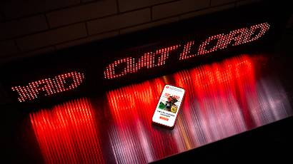 A series of connected images showing a mobile phone displaying content against a dramatic red and black LED light wall background