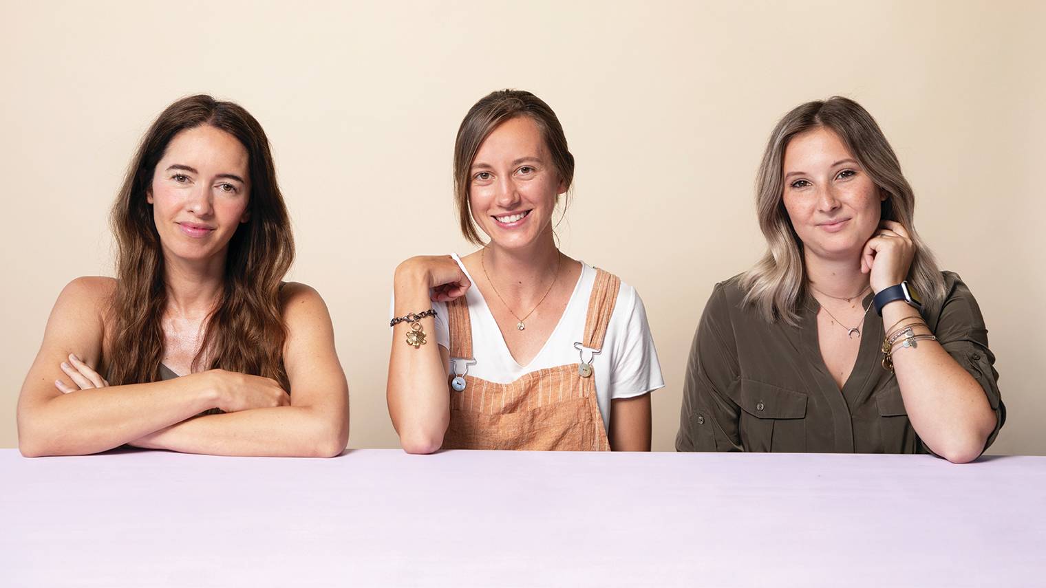 A photo of freelancers Marcy Chu, Paige Slaughter, and Mari Backus sitting together at a table.