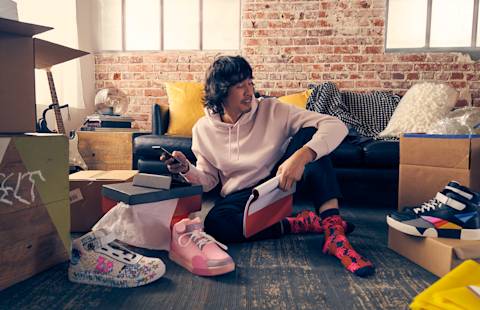 A man looking at his inventory of shoes.