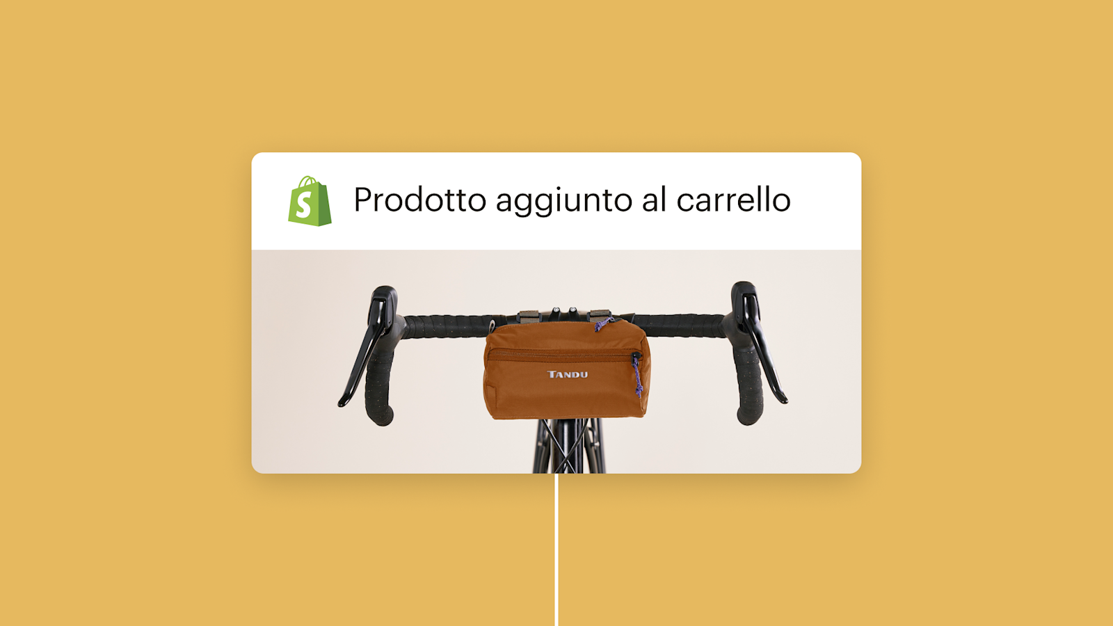 Borsa da manubrio marrone appesa sul manubrio nero di una bicicletta con il logo Shopify e il testo "Product added to cart"