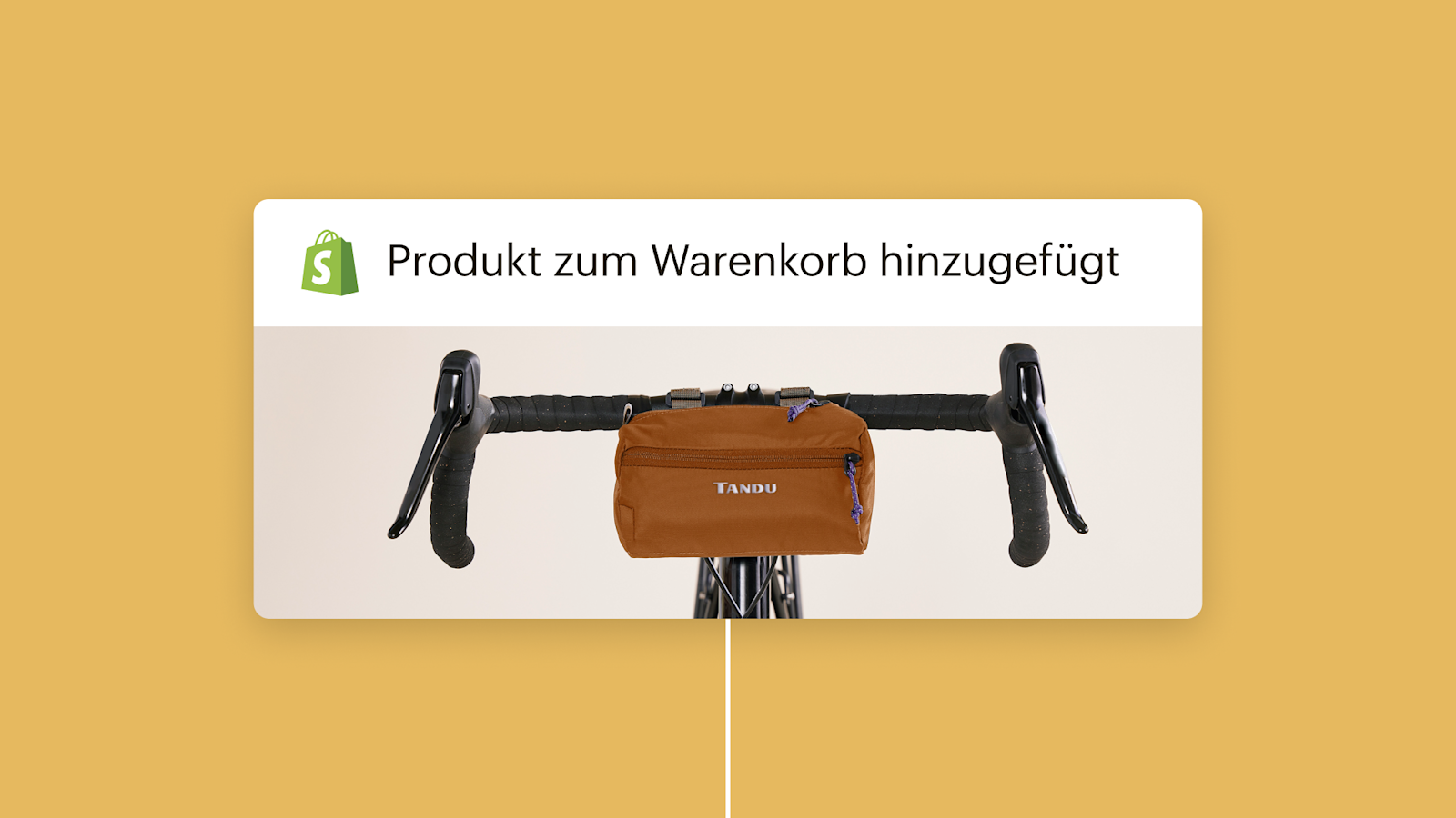 Braune Lenkertasche auf schwarzem Fahrradlenker montiert mit Shopify-Logo und dem Text „Produkt zum Warenkorb hinzugefügt“ darüber