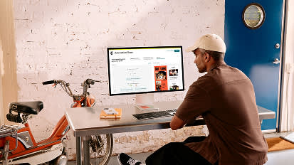Person on computer in a room with a bicycle