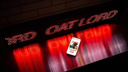 A series of connected images showing a smartphone displaying the Target app against a backdrop of red and white illuminated LED lights